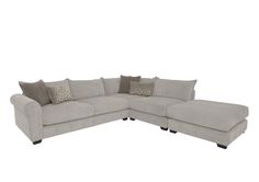 a gray sectional couch with pillows on it