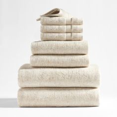 a stack of white towels on top of each other in front of a white background