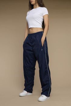 Nikes Track Pants, How To Style Windbreaker Pants, Nike Windbreaker Track Pants, Retro Nike Pants, Baggy Nike Pants Outfit, Vintage Nike Parachute Pants, Nike And Adidas Outfits, Nike Windbreaker Pants Outfit, Blue Nike Track Pants Outfit