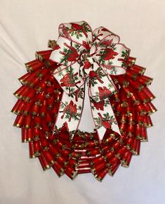 a red and white christmas wreath with bells