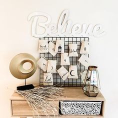 a wooden table topped with lots of white pillows and decorative items on top of it