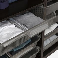 an open drawer with clothes in it