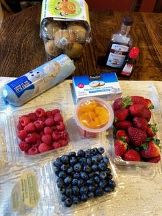 fruits, yogurt, and other ingredients are on the table ready to be eaten