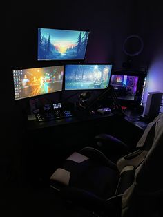 three computer monitors sitting on top of a desk