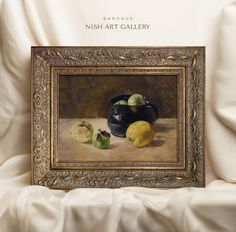 an oil painting of fruit on display in a gold frame with white draping