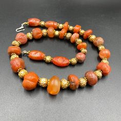 The Rare Unique PEMA RAKA Carnelian Amulet Prayer Beads Necklace From Himalayan Tibet The Age Of This Beads Are More than 1000 years Old As You Can See From Its Conditions Very Oily Smooth Skin Of This Pema Beads Some Gold Plated Wax and Gold Color Brass Beads Are Used As Spacers Rare Items For Collections Beaded Carnelian Round Beads Jewelry, Traditional Orange Beaded Bracelets With Polished Beads, Traditional Rondelle Jewelry With Large Beads, Traditional Hand-strung Agate Jewelry, Traditional Carnelian Gemstone Jewelry, Traditional Agate Jewelry With Large Beads, Orange Amulet-style Jewelry With Large Beads, Spiritual Carnelian Round Beads Jewelry, Artisan Carnelian Beaded Necklace