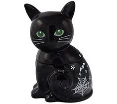 a black cat figurine with green eyes