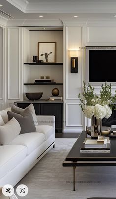 a living room filled with furniture and a flat screen tv mounted on the wall above a fireplace