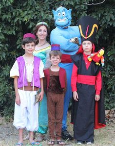 a group of people standing next to each other wearing costumes and posing for the camera