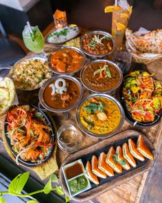 a wooden table topped with lots of food