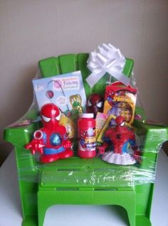 a green plastic chair filled with toys and other items sitting on top of a table