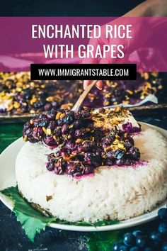 a plate with rice and blueberries on it next to a pan filled with grapes