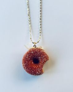 a necklace with a donut hanging from it's side