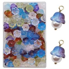 two pieces of glass beads with flowers and pearls in them, one is blue and the other is white