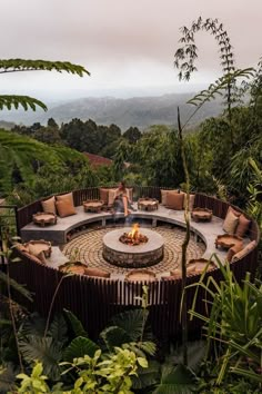 a circular fire pit surrounded by greenery and trees