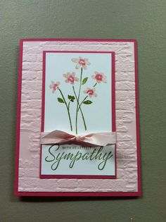 a card with pink flowers on it and the words sympathy written in cursive writing