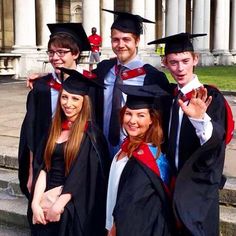 a group of young people standing next to each other in graduation gowns and caps