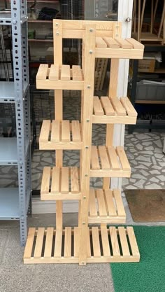 a wooden shelf sitting on top of a green mat in front of a store window