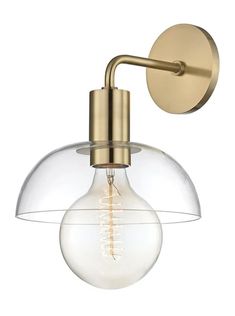 an antique brass wall light with clear glass globe shade