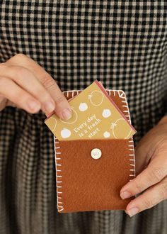 a woman is holding a card in her pocket