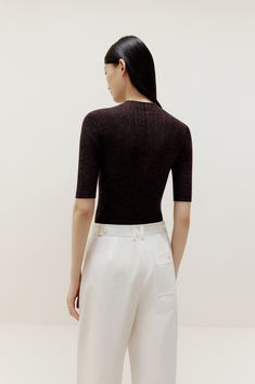 Don’t think twice, just toss this on for instant, effortless style! Our Half Sleeve Sweater is knit from irresistibly soft lightweight wool, making it the perfect top and layering piece. Details Materials & Care Shipping & Returns • Made from Merino wool – naturally warm and breathable with a glossy sheen.• A stylish fine-knit top featuring an elegant mock neck• Half sleeves hit right at the elbow for a super flattering cut.• Tailored for a streamlined fit for easy layering. Size M is 22.8" in l Versatile Viscose Tops For Fall, Textured Knit Fitted Tops For Workwear, Fitted Textured Knit Tops For Work, Soft Knit Fitted Tops For Fall, Fitted Soft Knit Tops For Fall, Turtleneck Pointelle Knit Top, Textured Knit Turtleneck Top For Layering, Pointelle Knit Turtleneck Top, Fall Viscose Tops For Layering