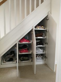 an under the stairs storage area with shoes