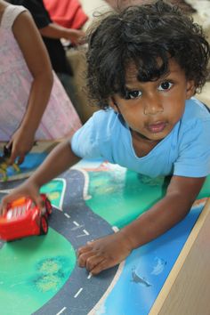 a young child playing with toys on the floor