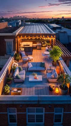 an outdoor living area with couches, tables and lights on the roof terrace at night