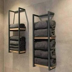 two shelves with towels hanging on them in a bathroom