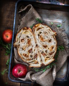 two pieces of bread sitting on top of a pan next to an apple and another piece of fruit