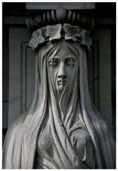 black and white photograph of a statue with long hair