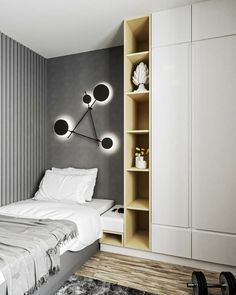 a bedroom with grey walls, white bedding and black accents on the headboard