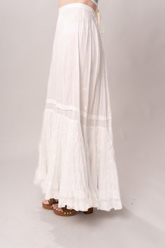 Stunning Edwardian 1910’s white cotton and lace maxi petticoat skirt. With a pretty flare silhouette, panel lace detail, and a button closure at waist. Good vintage condition, with normal wear and condition for its age. Some areas of visible mending a minor staining - see pictures. Best fits modern size XS/S Waist 26”Length 42” Featured top is the Blue Doll Quilt Corset from our friends at Psychic Outlaw. Model’s Measurements:Height 5’9”Chest 34”Waist 29”Hips 36.5” Lace Maxi Skirt With Lace Trim, Flowy Maxi Skirt With Lace Trim, White Lace Patchwork Long Skirt, Daywear Long Lace Skirt, Bohemian Long Skirt For Daywear, White Lace Vintage Bottoms, Vintage White Lace Bottoms, White Vintage Lace Bottoms, Summer Maxi Bottoms With Lace Trim