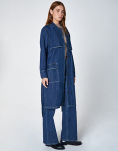 // // // Wash: Exhale DESCRIPTION Sukie, our long duster jacket. Featuring a back rain flap, bottom hem button closure vent, and self-tie at the waistband. Includes contrast stitching and oversized flap pockets. STYLE# EW3000130 FABRIC + CARE Non-stretch lightweight 6.2 oz. denim. [ 100% cotton ] Machine wash cold with like colors, do not bleach, tumble dry low, low iron if needed.*We recommend hand wash & hang dry for best results. DETAILS Points of Measure 43" Chest 42.25" LengthModel is 5`10" Denim Trench Coat, Long Duster, Pleated Jacket, Duster Jacket, Low Low, Chore Jacket, Wide Boots, Low Iron, Utility Jacket