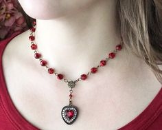 "Big scarlet red and romantic heart pendant necklace with lots and lots of sparkle! Adjustable antiqued brass chain with a lobster claw clasp allows a longer 18\" length necklace or go for a shorter choker style necklace when the mood suits you. Super versatile and will fit into your wardrobe easily. I've used sparkly red faceted glass beads for that extra shine. The pretty heart setting drops perfectly for a lovely focal point to this necklace. Your beautiful necklace will be carefully packaged Big Statement Necklace, Red Statement Necklace, Vintage Red Necklace With Heart Charm, Vintage Heart Necklace With Lobster Clasp For Valentine's Day, Vintage Red Jewelry With Heart Beads, Red Heart Beads Necklace For Wedding, Vintage Red Heart-shaped Necklace, Vintage Heart Necklace For Valentine's Day Party, Vintage Red Heart Necklace