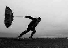 a man running with an umbrella in his hand