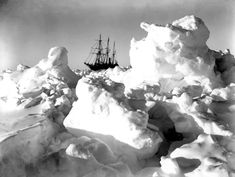 an old ship is in the middle of icebergs and snow drifts on land