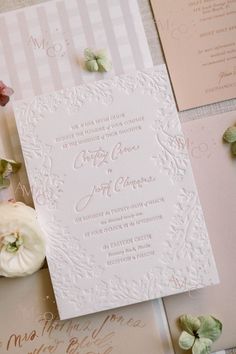 the wedding stationery is laid out and ready for guests to come home from their ceremony