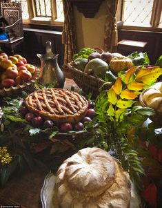 a table topped with lots of different types of pies and other food on top of it