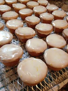 there are many glazed cupcakes on the cooling rack