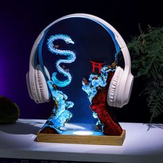 headphones on top of a blue and red glass sculpture with the word's in chinese writing