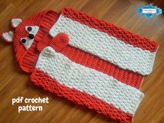 two red and white knitted items sitting on top of a wooden floor