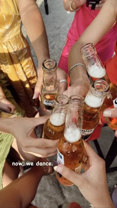 a group of people holding beer bottles in each other's hands with the caption now we dance