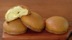 three pieces of bread sitting on top of a wooden cutting board