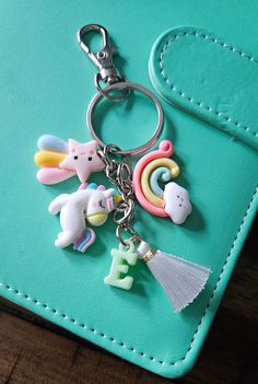 a keychain that has some small toys on it's side and is attached to a wallet