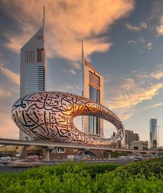 a large building with an intricate design on it's side in the middle of a city