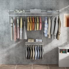 an organized closet with clothes hanging on racks