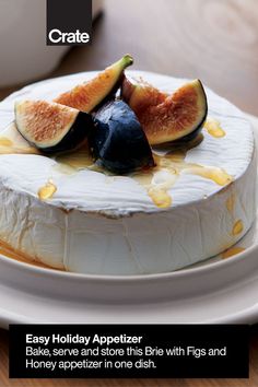 a cake with figs on it sitting on a plate