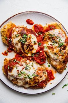 three pieces of chicken parmesan on a plate