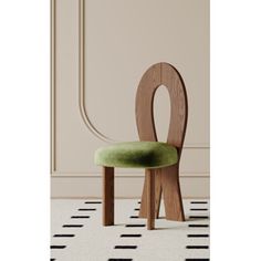 a green chair sitting on top of a white rug in front of a beige wall